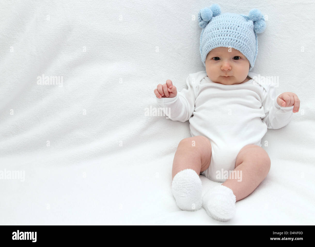 Beautiful baby in blue knitted hat Stock Photo