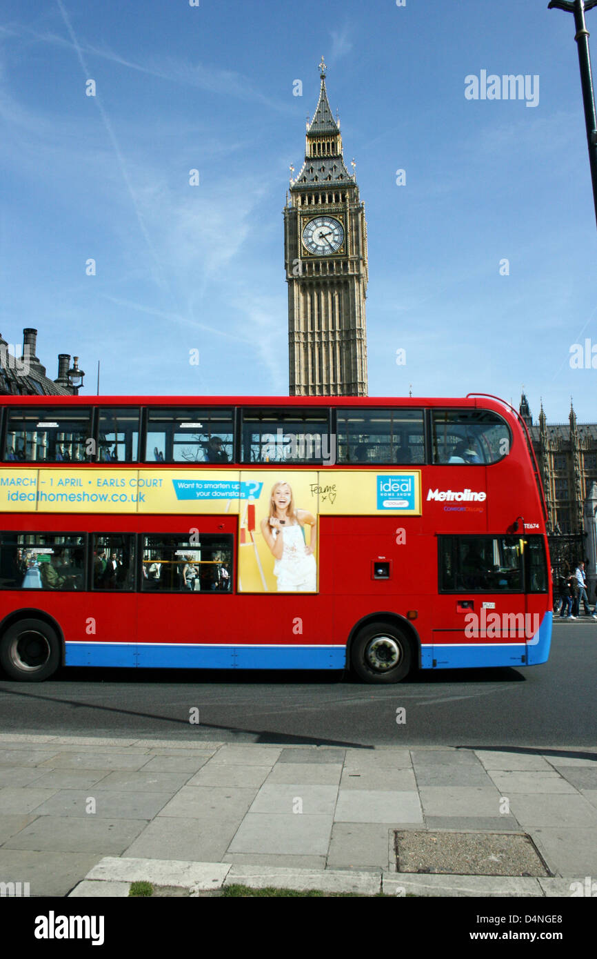 London red bus passes Big Ben, House of Parliament, London, England Stock Photo