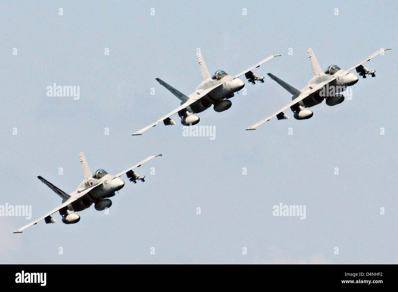 US Navy F/A-18C Hornet fighter aircraft fly in formation near the aircraft carrier USS Nimitz January 7, 2010 in the North Arabian Sea. Stock Photo