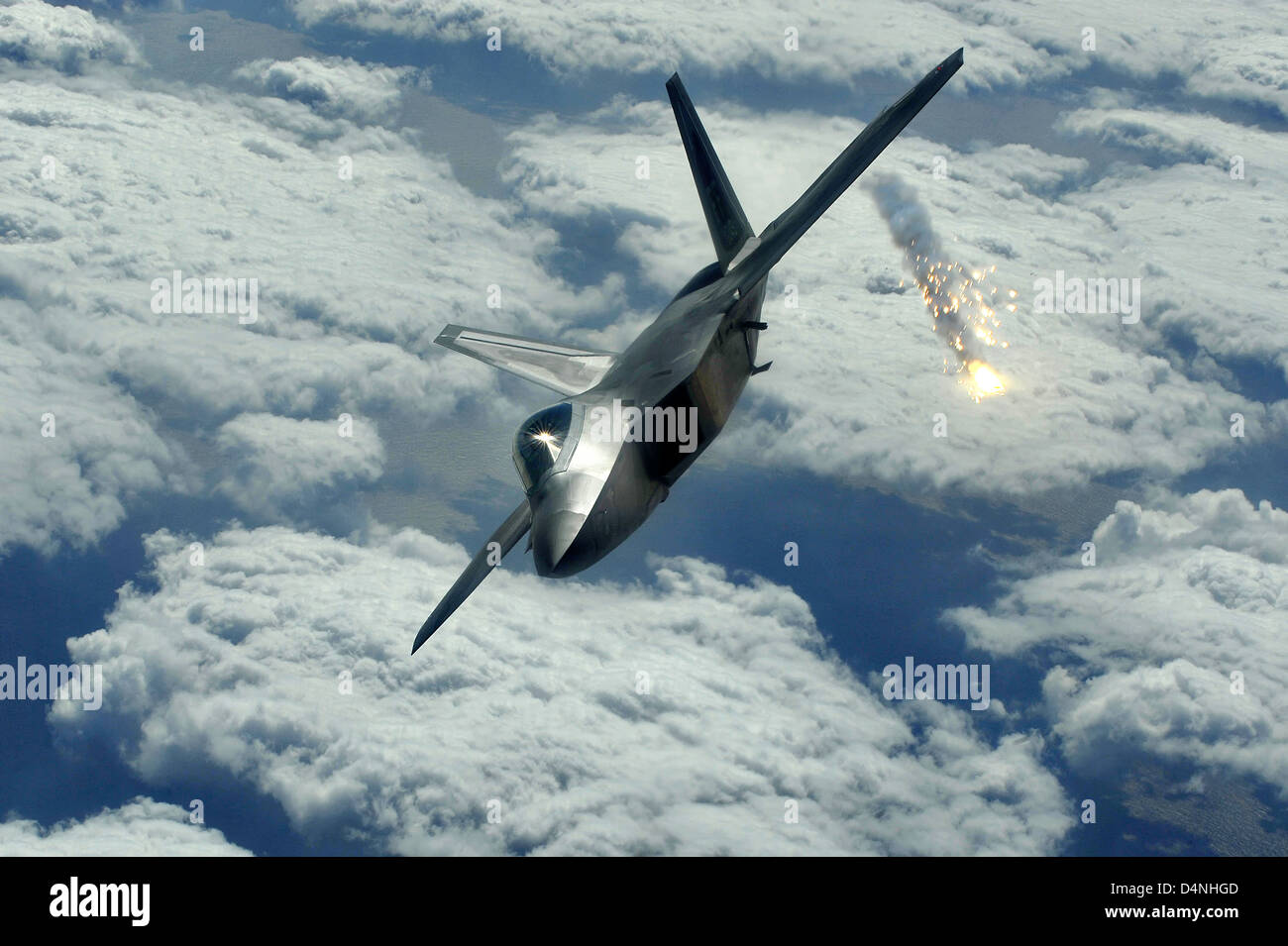 US Air Force F-22 Raptor stealth fighter aircraft releases flares during a flight over the Pacific Ocean January 15, 2009 near Kadena, Japan. Stock Photo