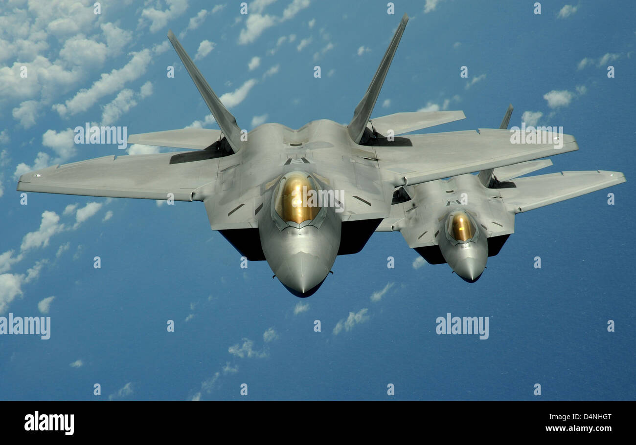 US Air Force F-22 Raptor stealth fighter aircraft fly over the Pacific Ocean during a theater security mission March 9, 2009 from Andersen Air Force Base, Guam. Stock Photo