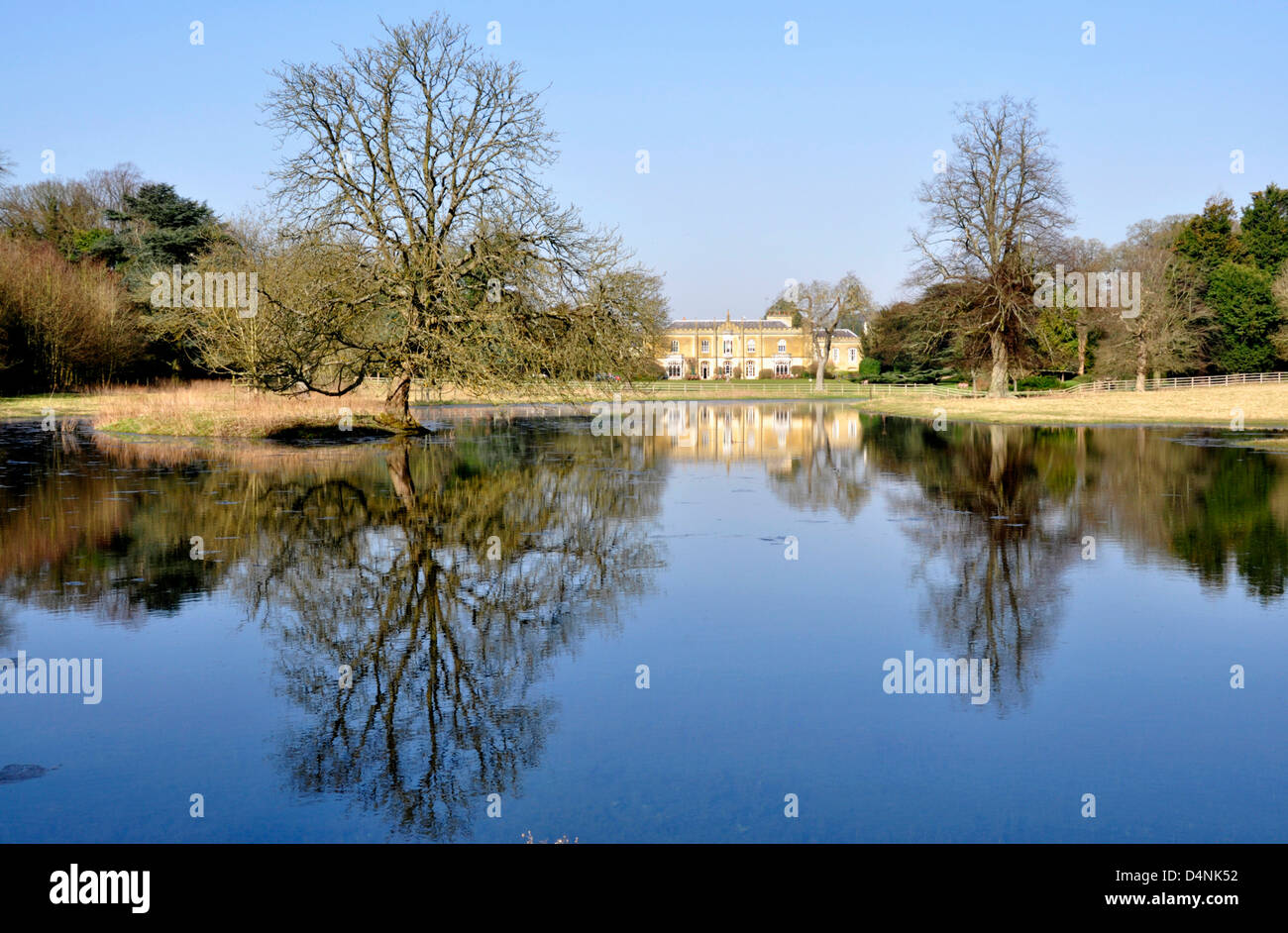 Chilterns Great Missenden the abbey across lake formed by river Misbourne - brilliant winter sunlight still water reflections. Stock Photo