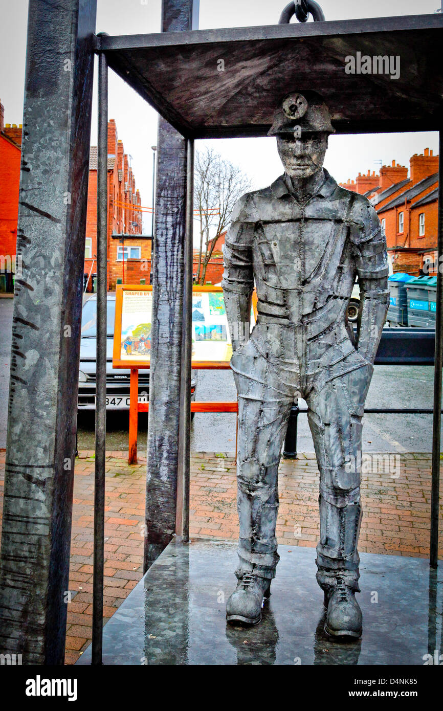 A dramatic life size sculpture monument to coal miners in an industrial