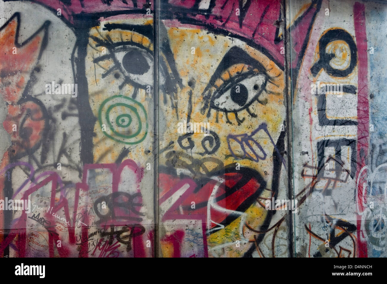 A piece of the Berlin wall in the La Defense area of Paris. It has been placed behind perspex to protect it. Stock Photo