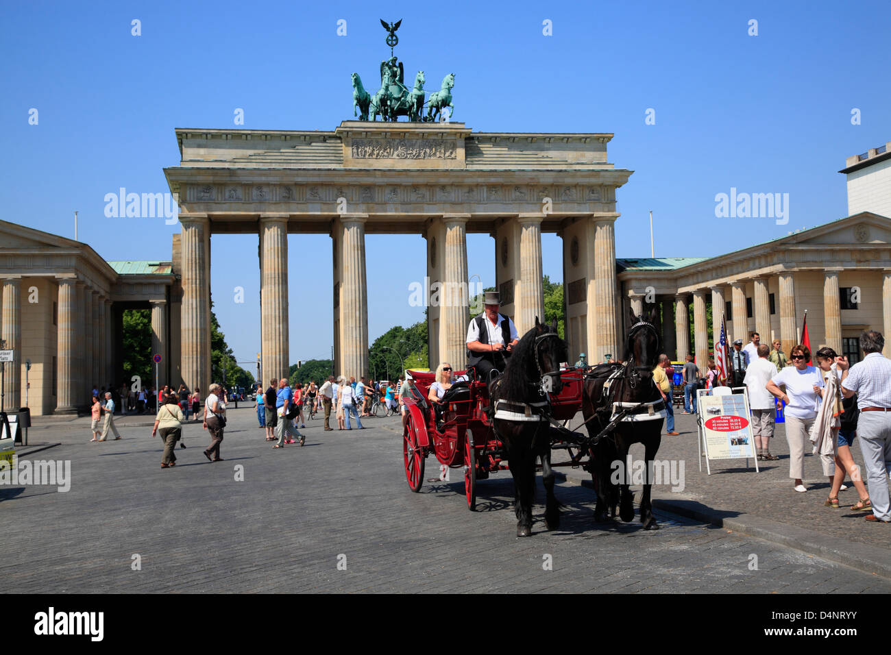 Horse drawn carriage starts sightseeing tour at Brandenburg Gate, Brandenburger Tor, Berlin, Germany Stock Photo