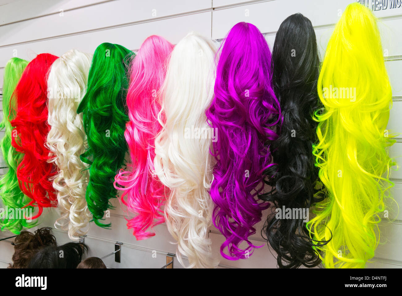 Coloured lady's wigs in a shop within Eldon Square Newcastle north east England UK Stock Photo