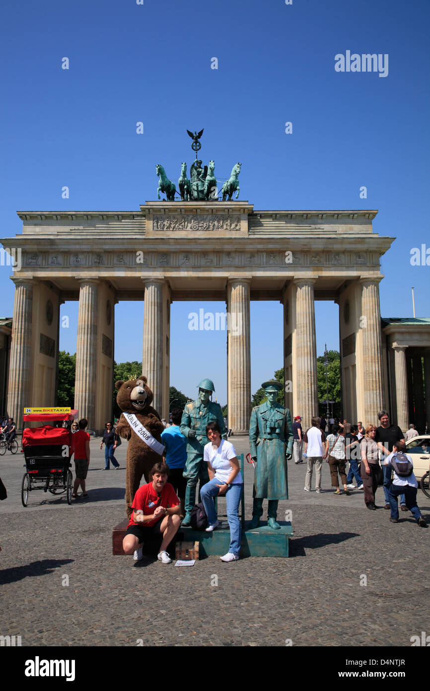 Street performer dressed as Soldiers posing for tourists in front of Brandenburg Gate, Berlin, Germany Stock Photo