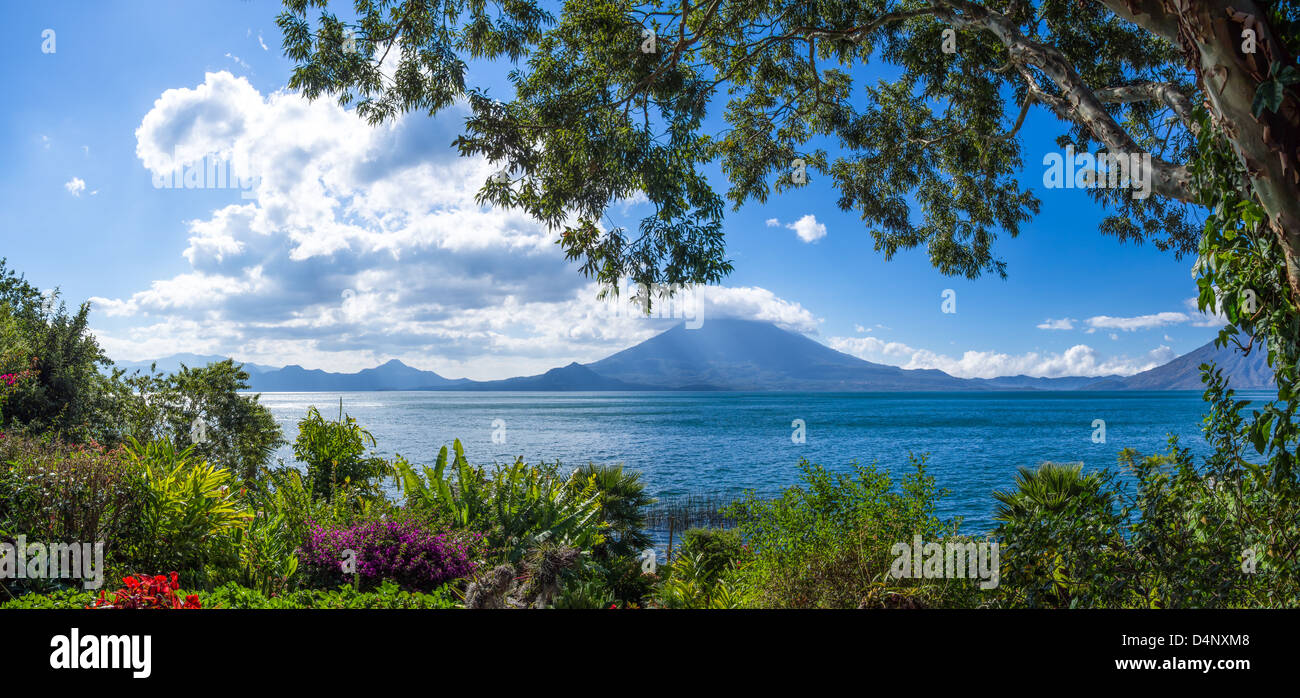 A beautiful view of Lake Atitlan and Toliman Volcano from a lush tropical garden Stock Photo