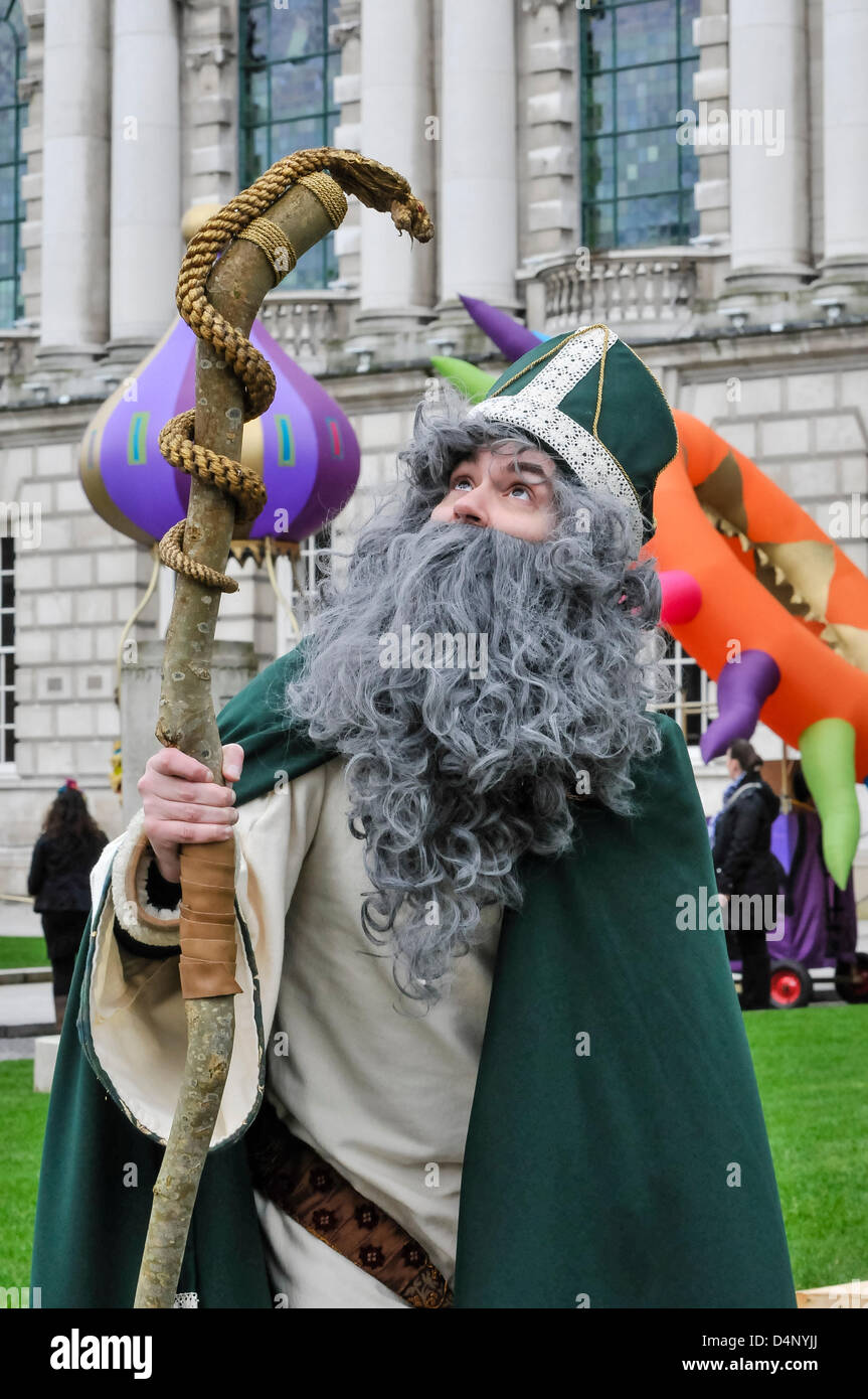 Belfast, Northern Ireland. 17th March, 2013.  Saint Patrick looks at the snake-shaped crook, in front of Belfast City Hall before the annual St Patrick's Day parade. Stock Photo