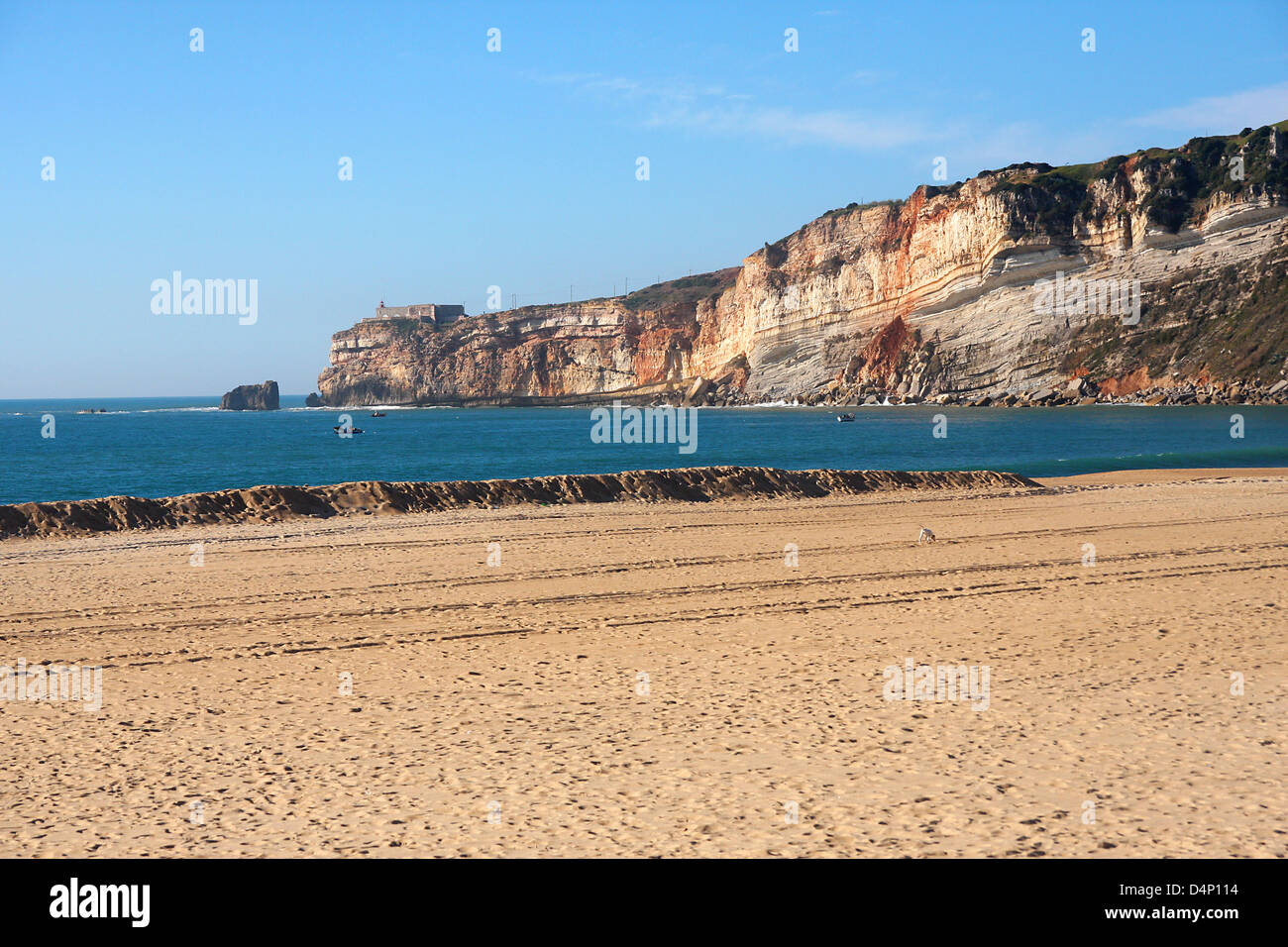 beach with cliff in Nazare, Portugal Stock Photo