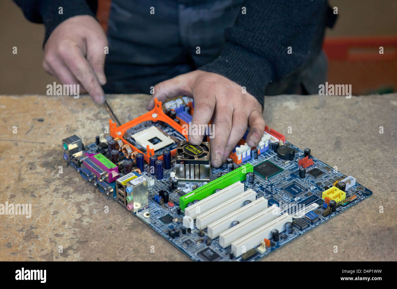 Berlin, Germany, the employee BRAL breaks a PC motherboard into parts Stock Photo
