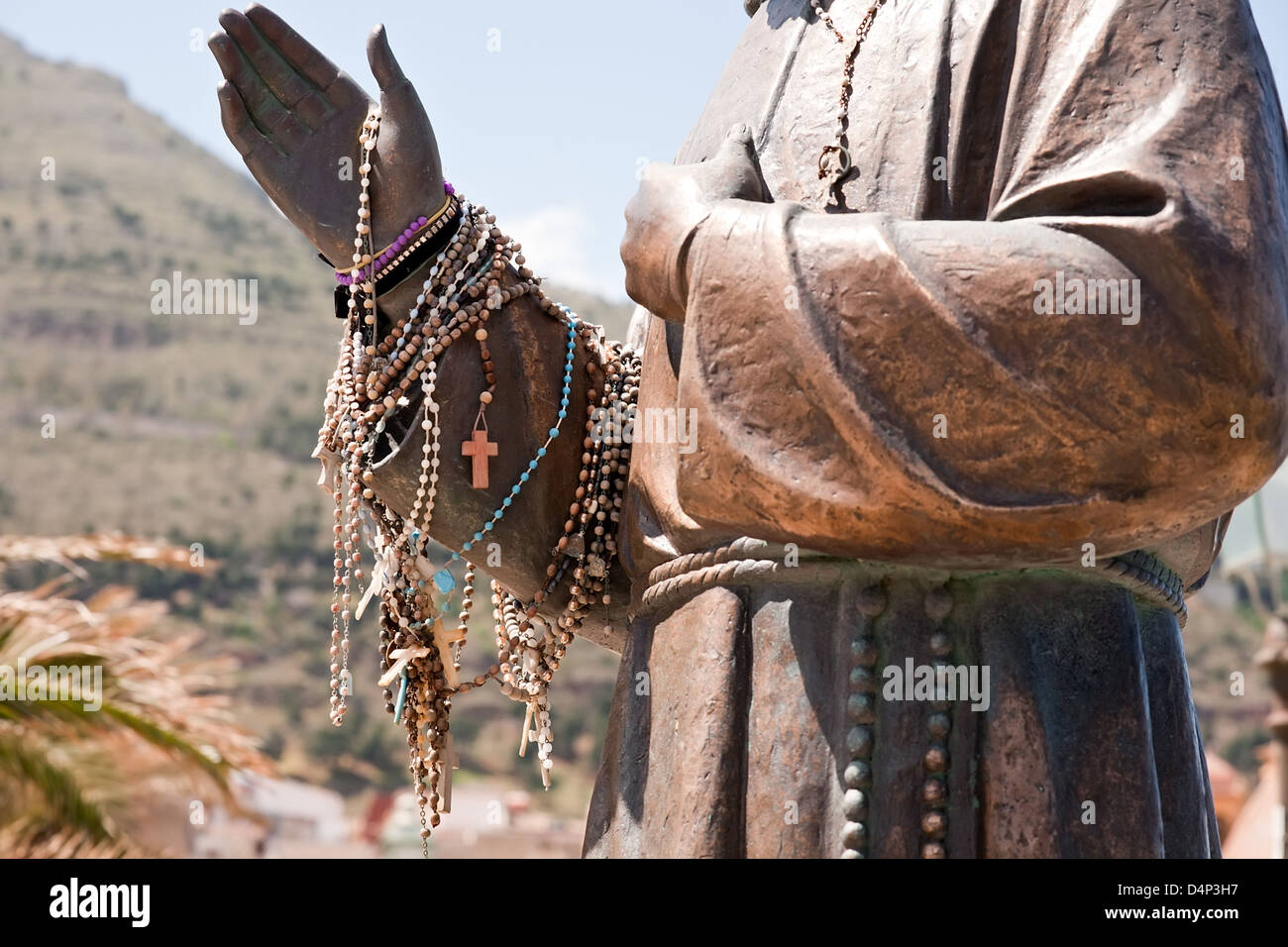 beads on a hand of priest statue, Castellammare del Golfo town, Sicily, Italy Stock Photo