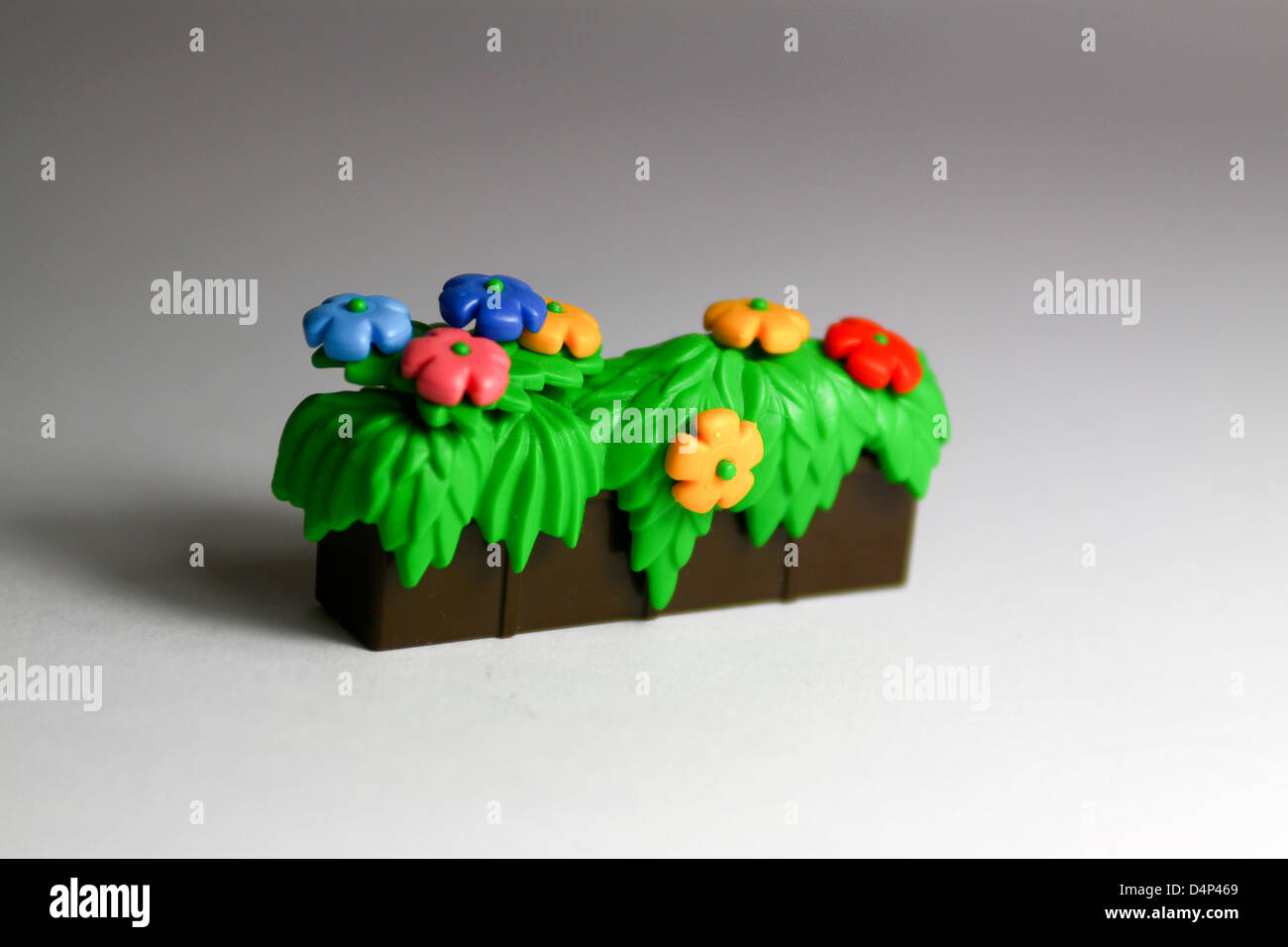 Toy plastic flowers in trough Stock Photo Alamy