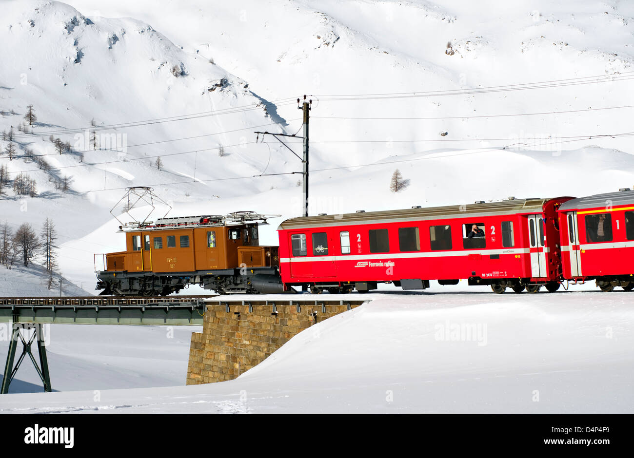 Crocodile locomotive at Bernina Pass in winter, Grisons, Switzerland Stock Photo