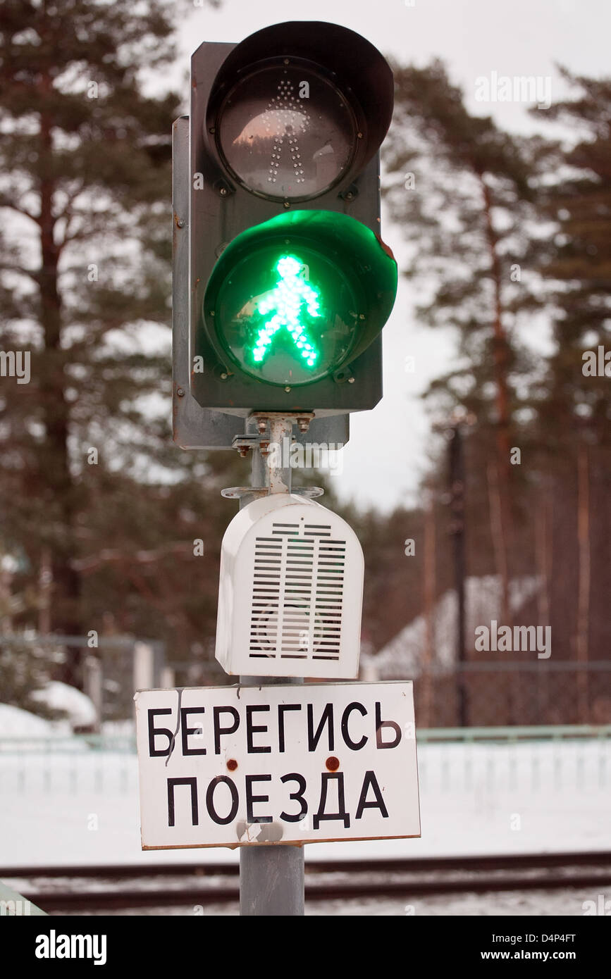 Russian signal light with green walking silhouette is on Stock Photo