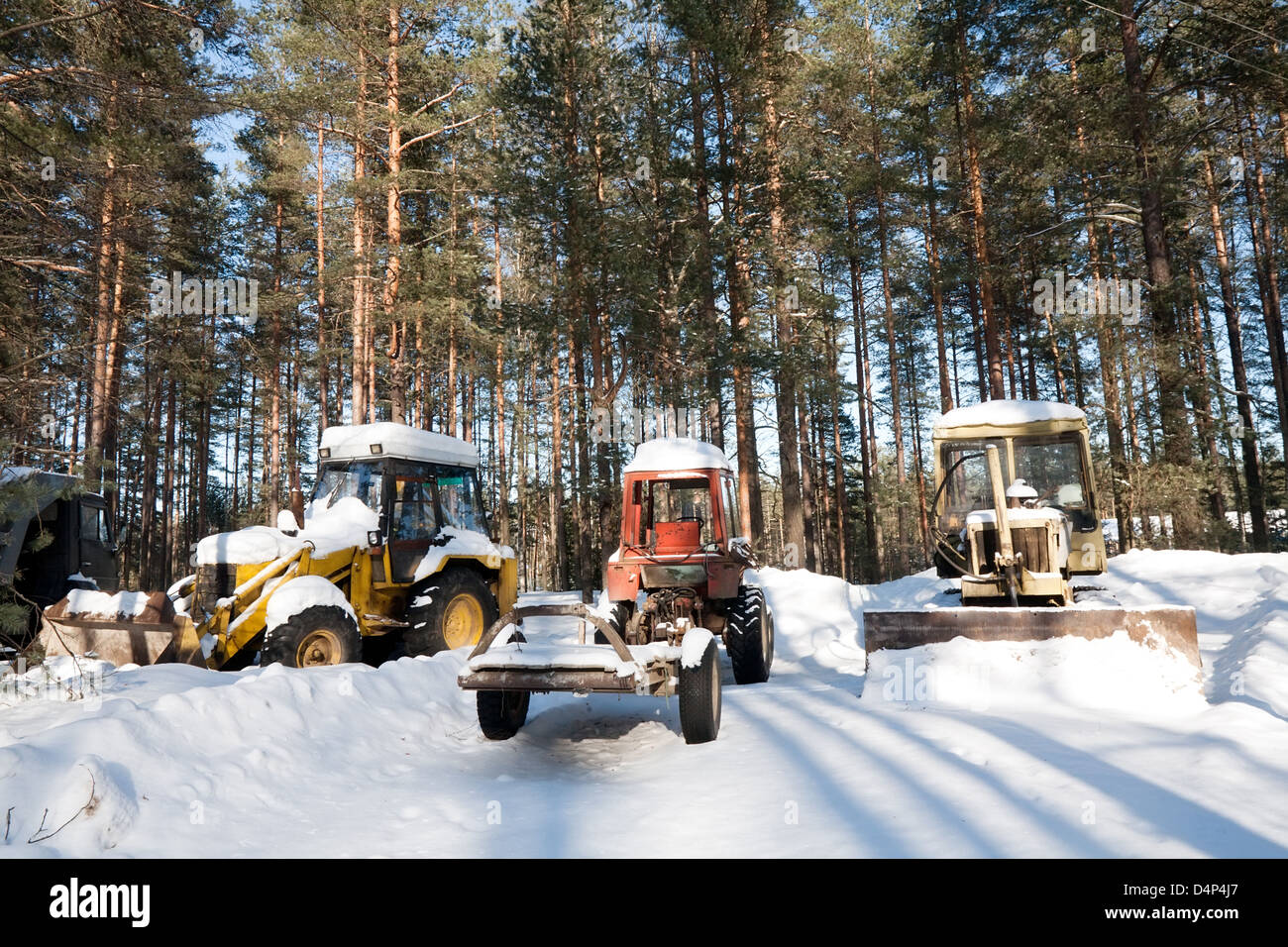 three old rusty tractors on snow winter background Stock Photo - Alamy