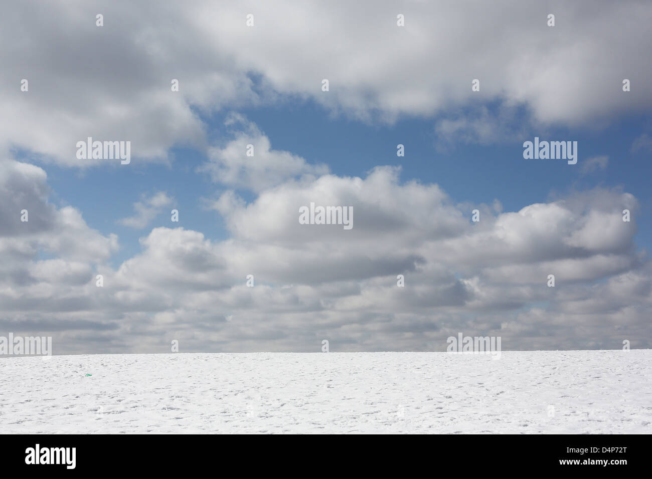 A snowy hillside under a cloudy sky. Stock Photo