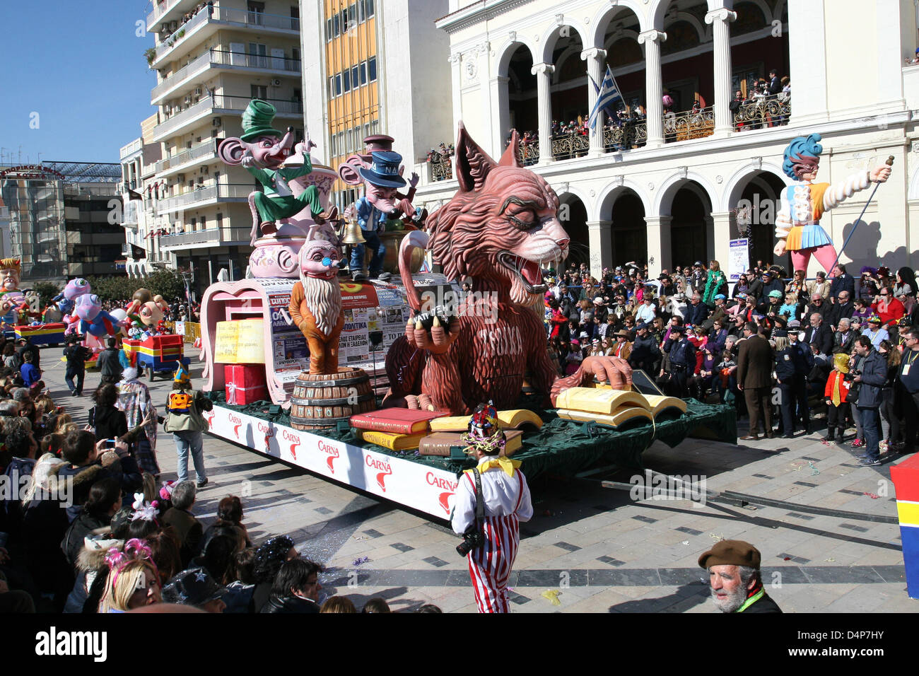 The cat carnival float at the Carnival in Patras Greece, 17 March 2013. Three mice hang a bell at the cat's tail. The mice reflect the greek government, in aristocratic appearance, has all the features of the political system. The cat, representing troika, in one hand holds three bombs which reads 'explosive economic growth' while reading the memorandums. The Patras Carnival is the largest event of its kind in Greece and one of the biggest in Europe, with more than 160 years of history. Photo: Menelaos Michalatos Stock Photo