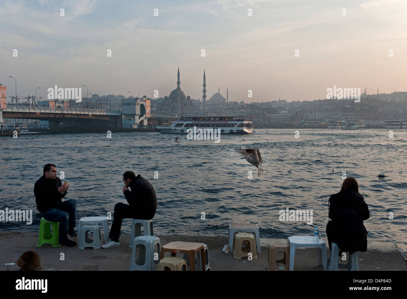 Istanbul, Turkey, locals sit on the Golden Horn Stock Photo