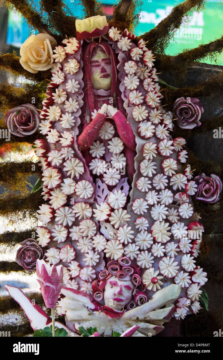 Our Lady of Guadalupe carved from radishes, with radish stars, radish roses, and radish cherub, Noche de Rabanos, Oaxaca, Mexico Stock Photo