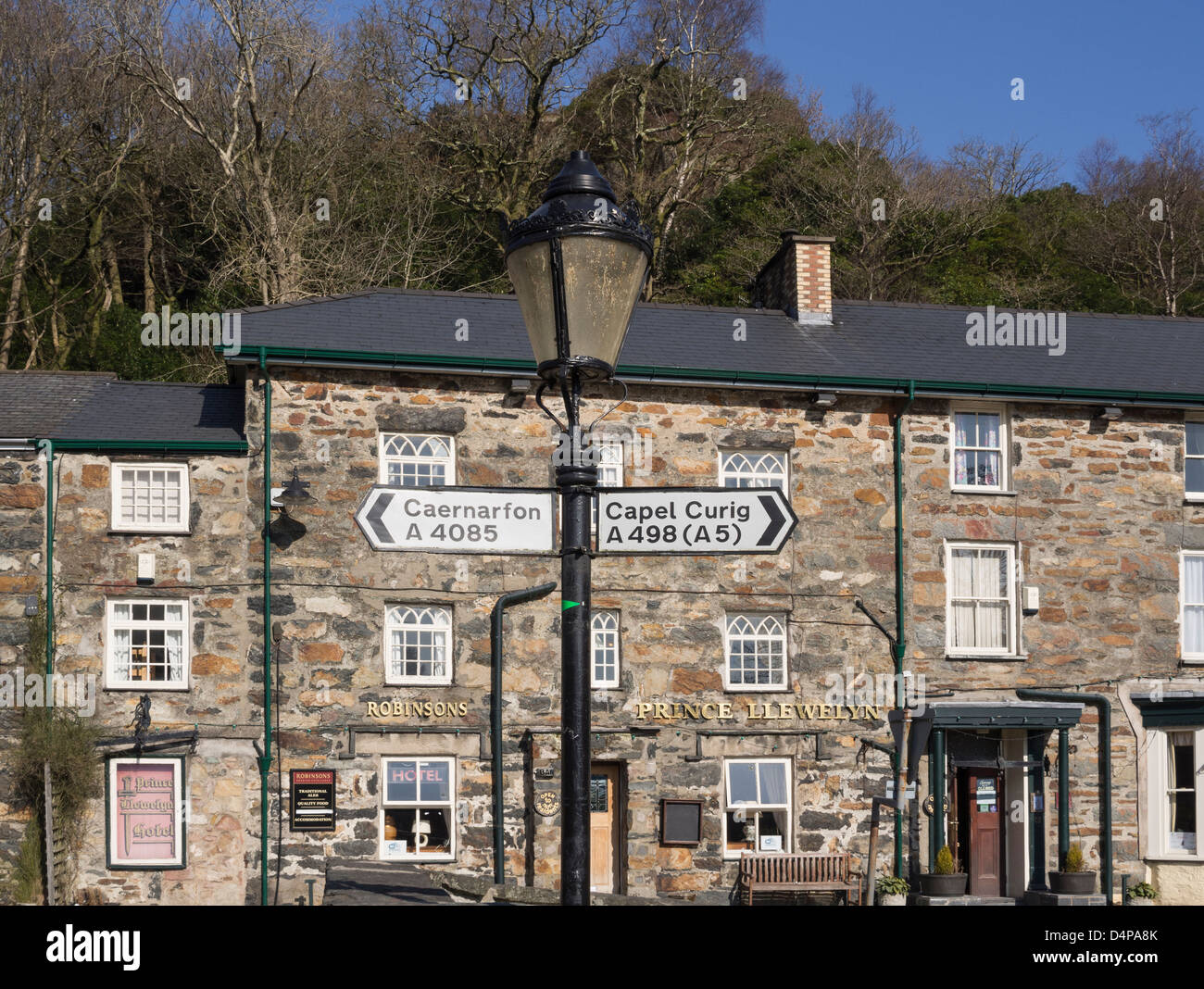 Direction signpost on an old fashioned lamppost by Prince Llewelyn Hotel in Beddgelert, Gwynedd, North Wales, UK, Britain Stock Photo