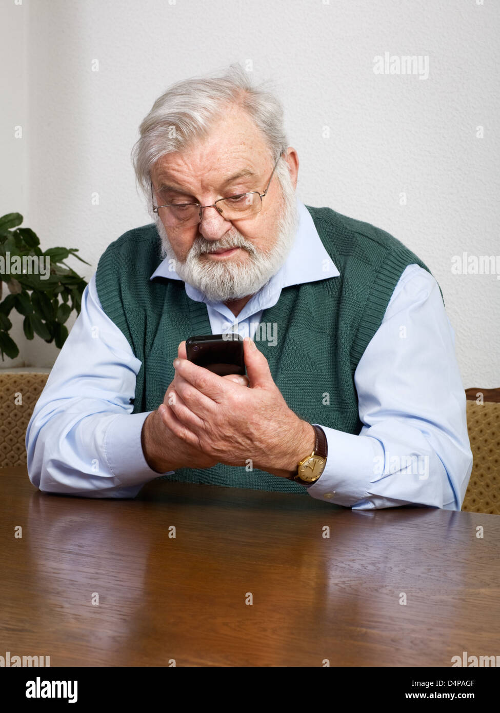 Senior man using his new smart phone Stock Photo