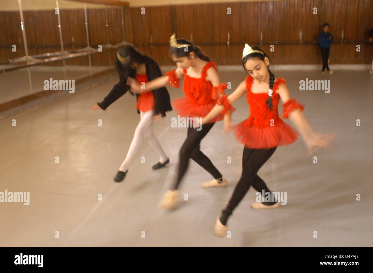 Dance Center of Baghdad girls rehearse every day trying to normalize life as if nothing happened outside these four walls. Stock Photo