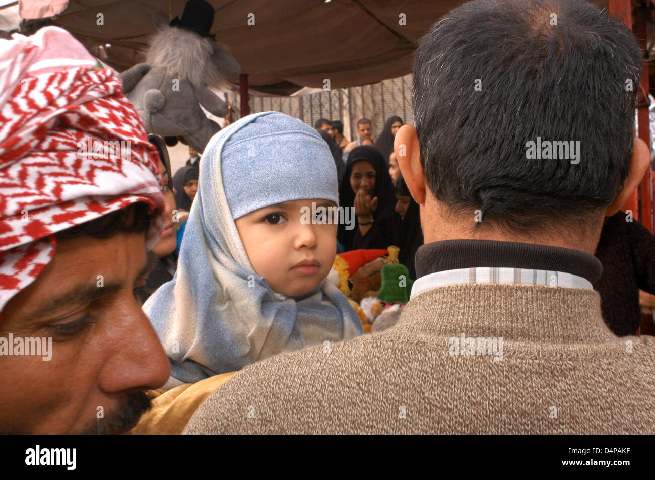 Market Diwaniyah. A family is buying with your child on the streets of downtown. Stock Photo
