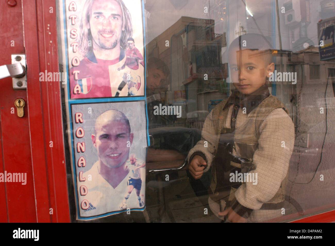A hairdresser any central streets of Diwaniyah. The best football players decorate the window, and as hairdressers all over the world, the new signings are always cause for conversation. Stock Photo