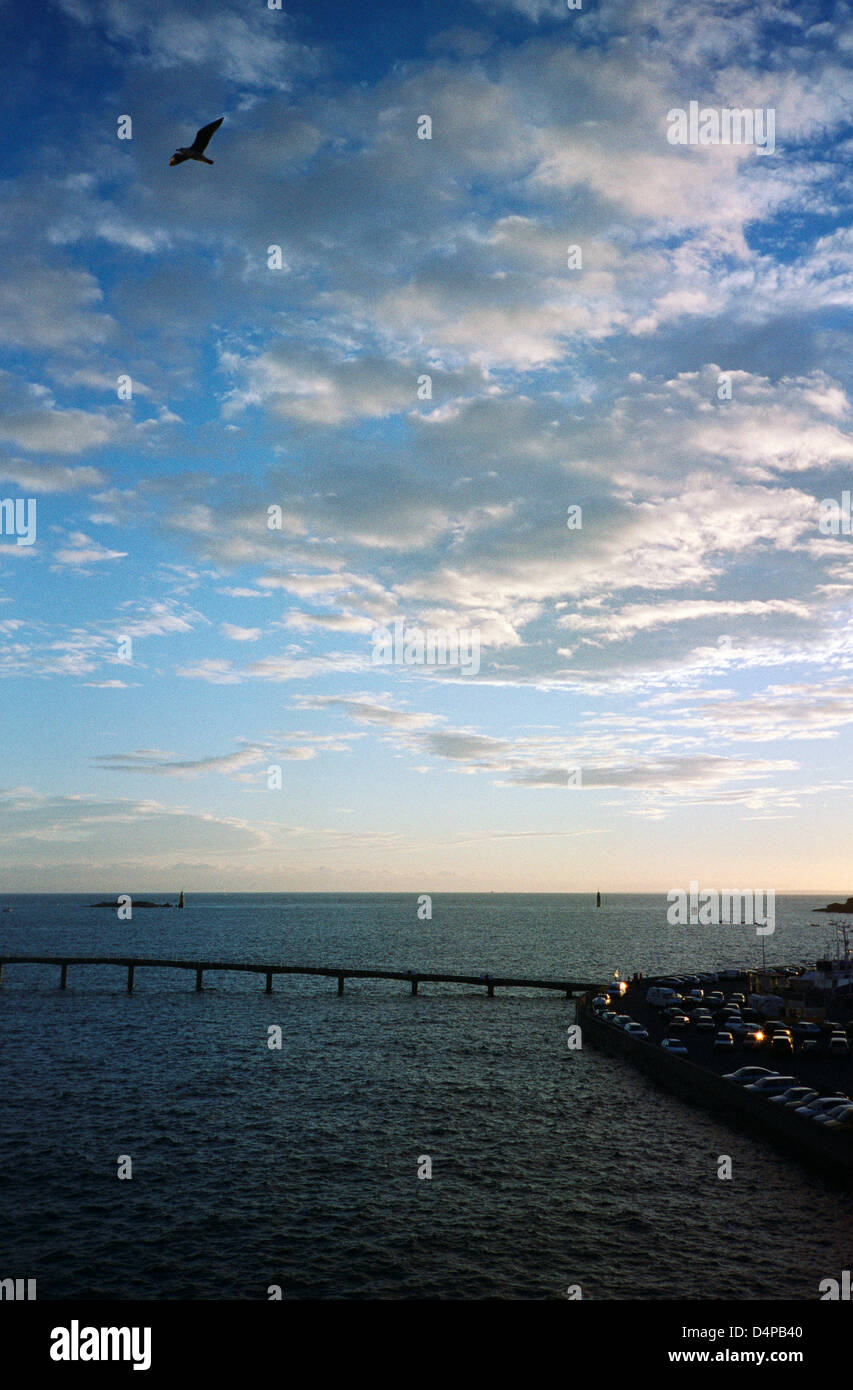 Harbour wall and causeway, Roscoff, Brittany, France, evening sky Stock Photo