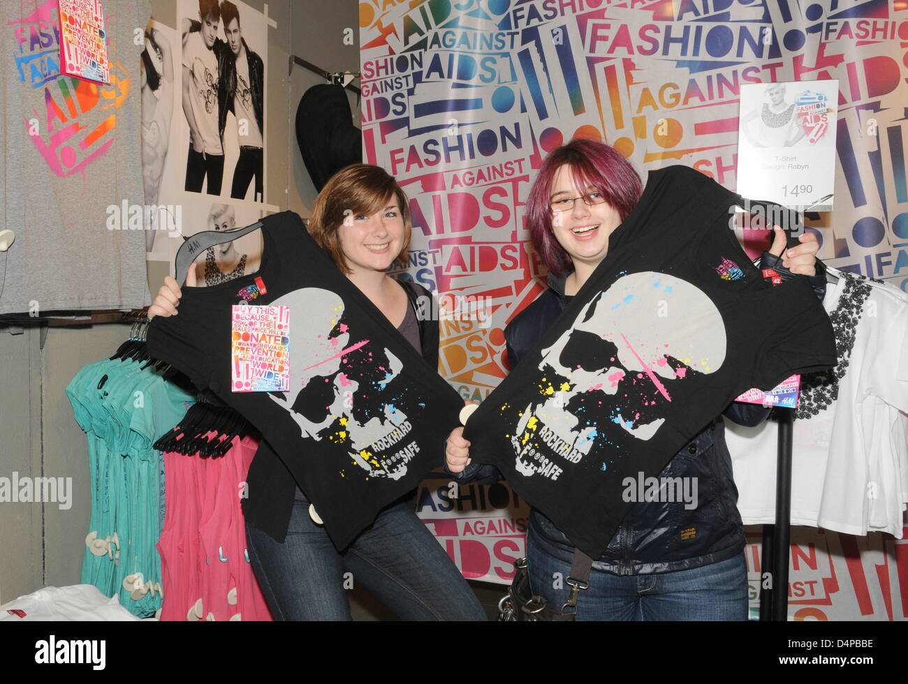 Julia Jung (L) and Sina Zander, fans of the band ?Tokio Hotel?, present  T-shirts designed by the band in a H&M store in Munich, Germany, 28 May  2009. The band designed the