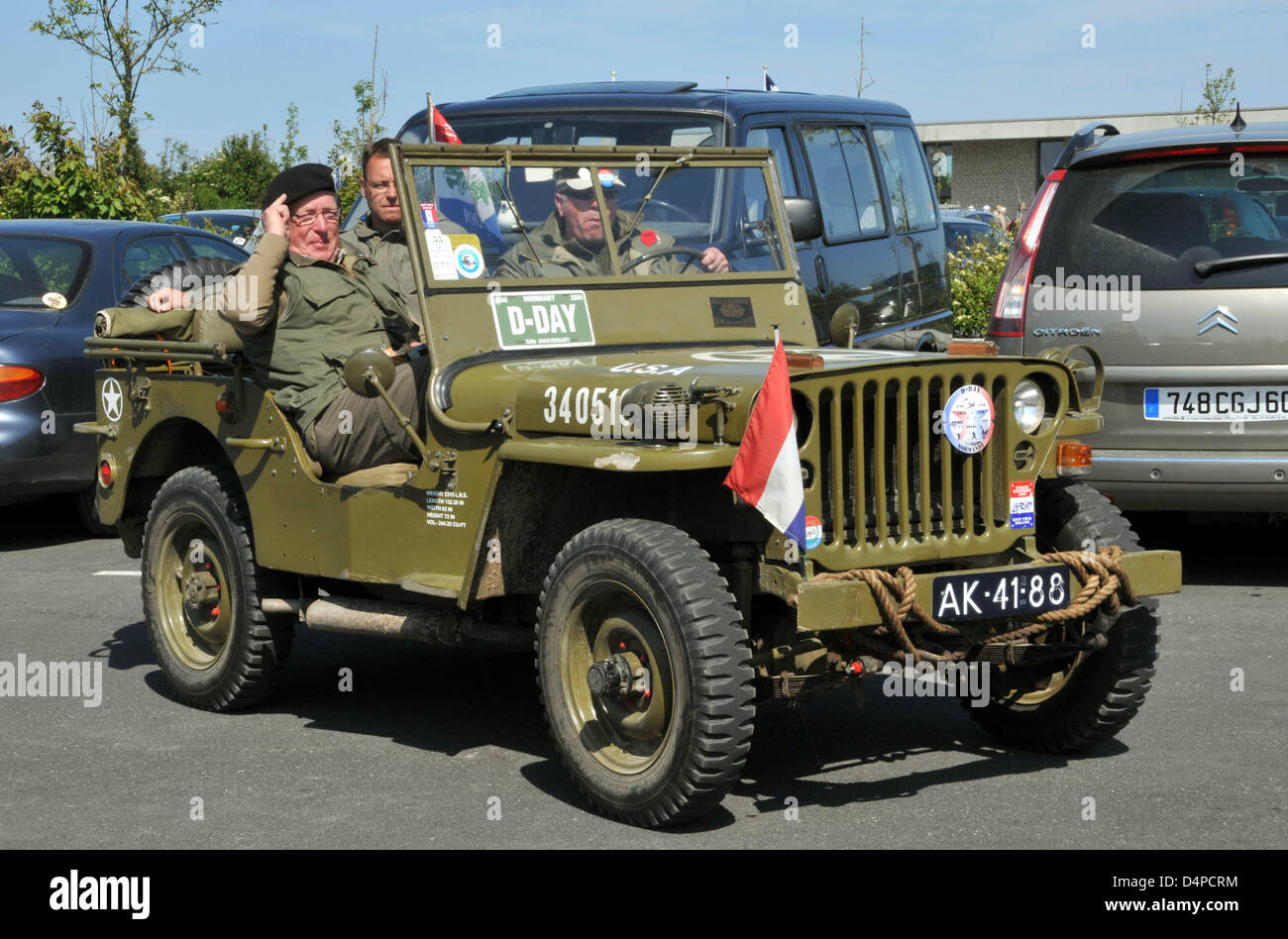 An US Jeep from World War II with Dutch passengers drives around on a ...