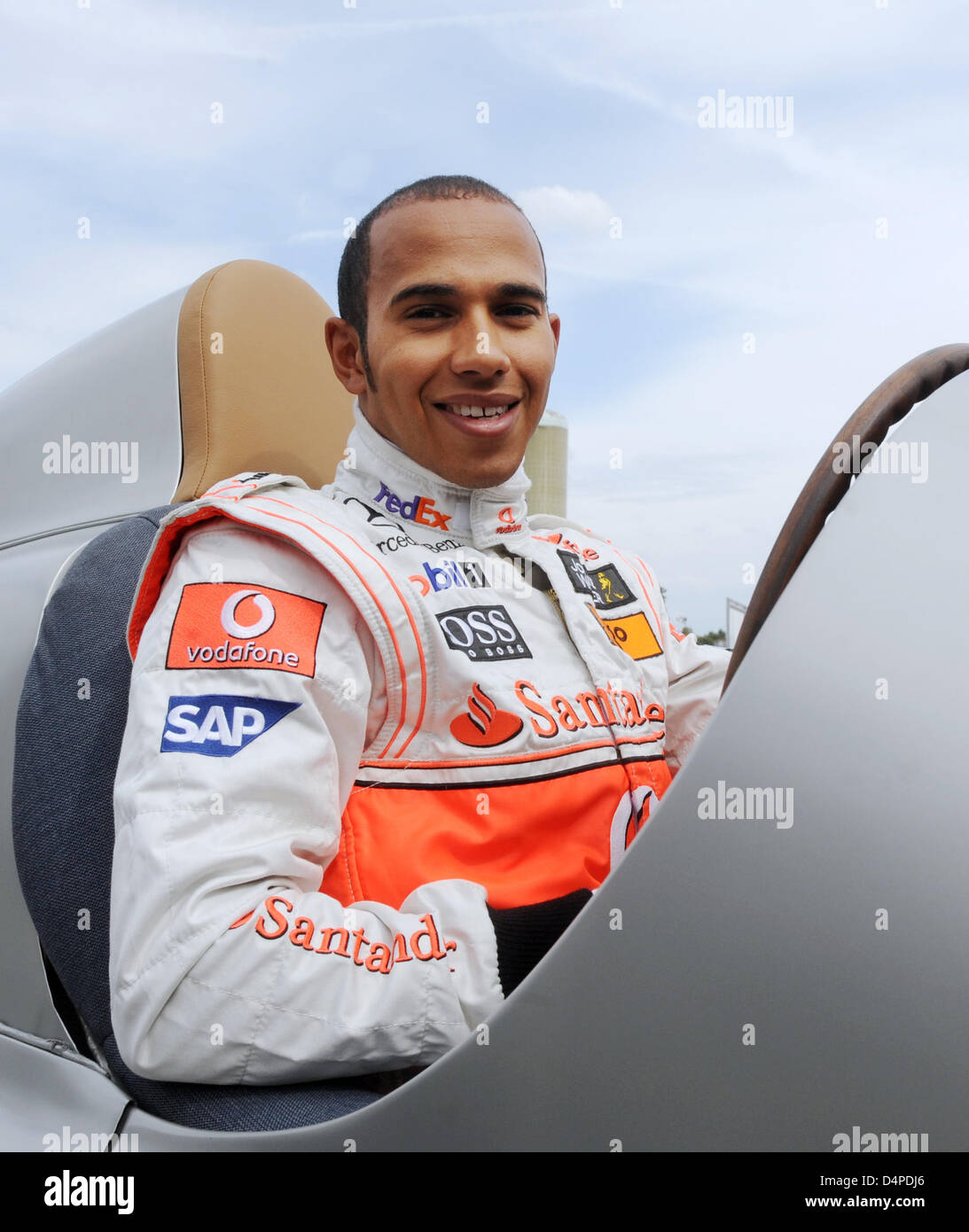 Reigning Formula One World Champion Lewis Hamilton sits in the cockpit 