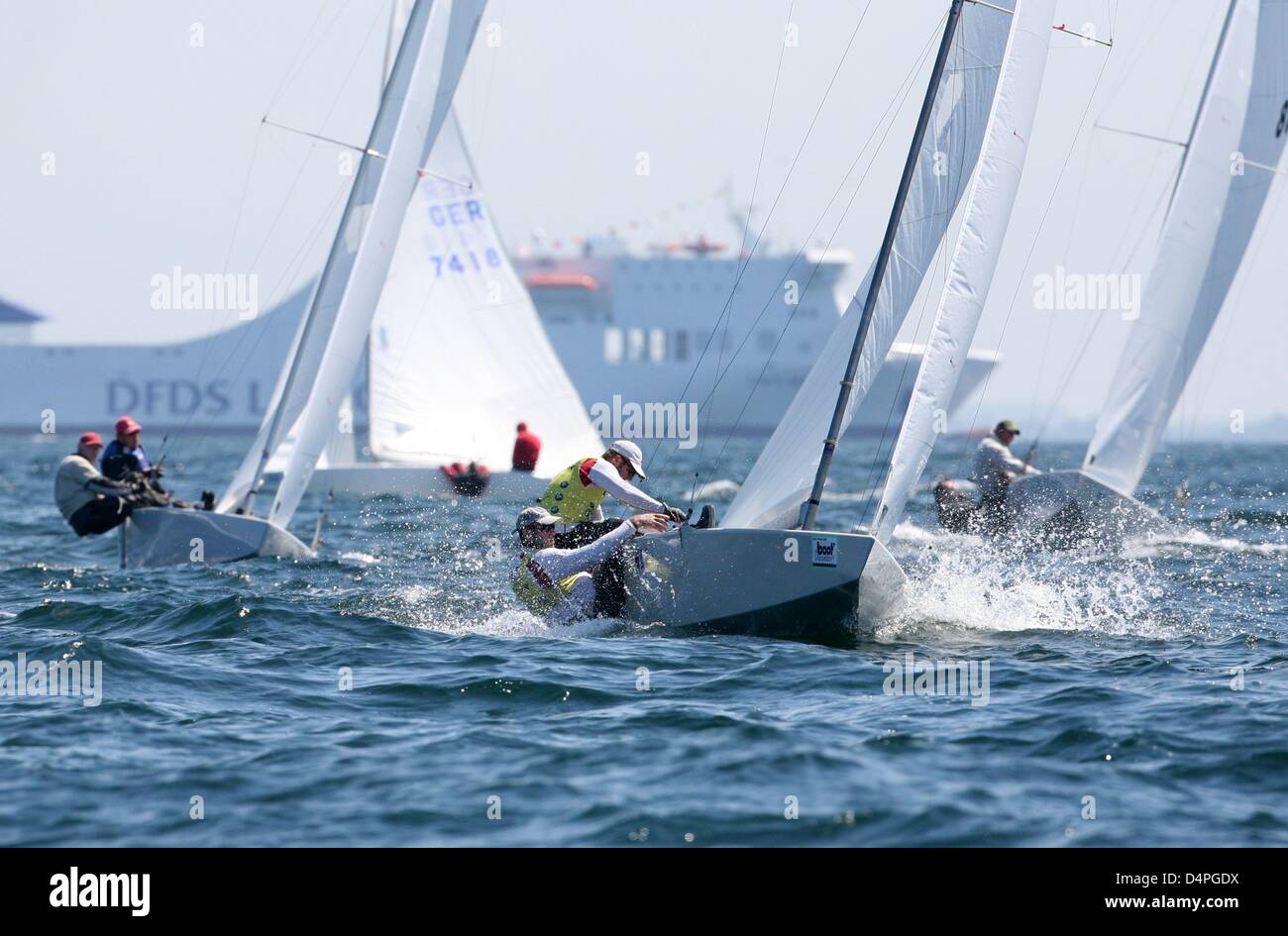 Star class boats compete during a regatta at the Kiel Week sailing