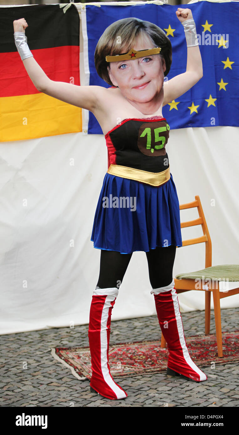 An activist of web movement Avaaz poses as German Chancellor Angela Merkel dressed-up as superhero in front of an US flag in Berlin, Germany, 25 June 2009. The activists call on Merkel and US President Obama to target climate goals reducing global warming to 1.5 degrees Celsius. Climate protection is a key issue on the agenda of Merkel meeting for talks with Obama. Photo: HANNIBAL Stock Photo