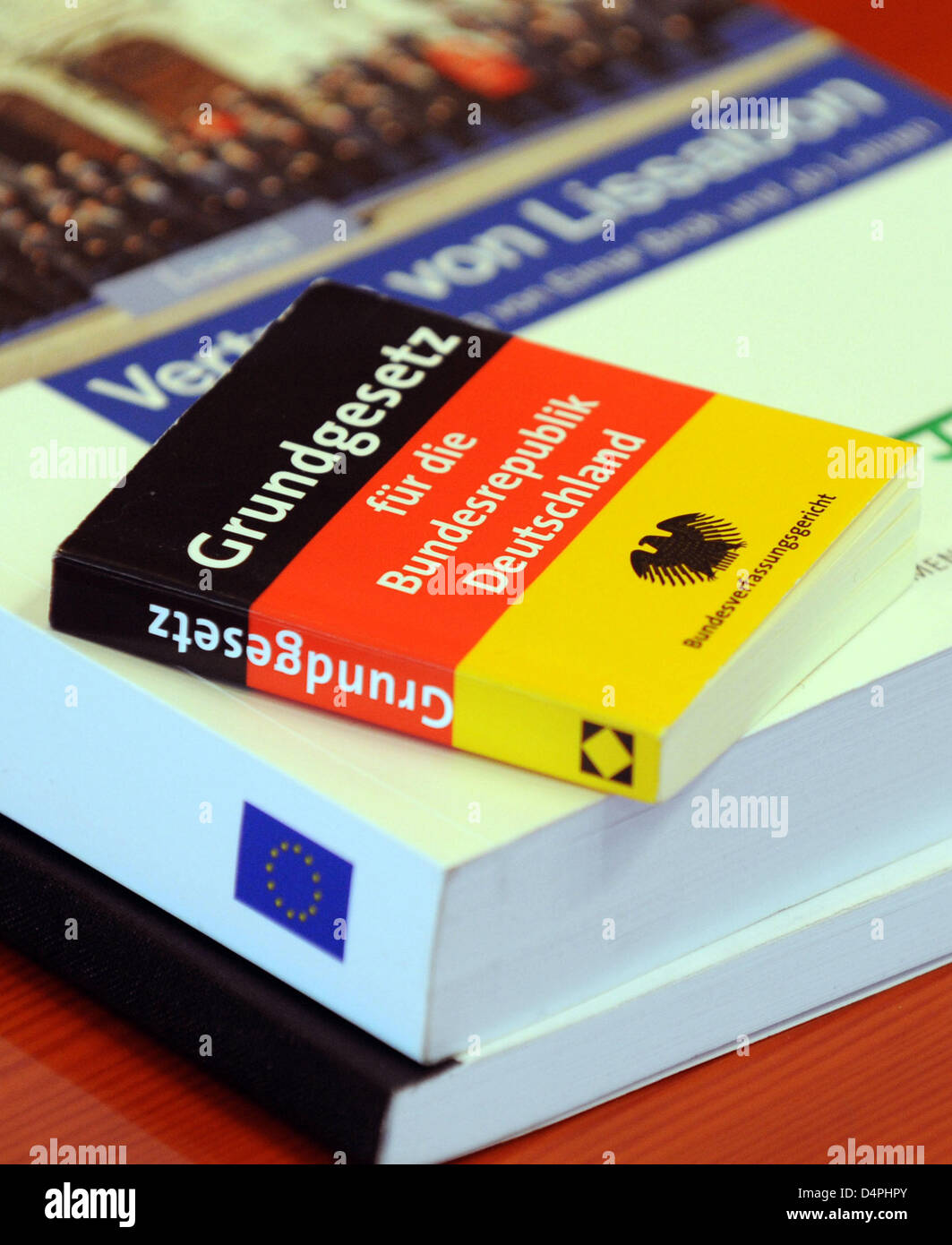 A miniature issue of the German Basic Law lies on top of an issue of the EU?s Lisbon Treaty at the Federal Constitutional Court (BVerfG) in Karlsruhe, Germany, 30 June 2009. The court demanded changes to German federal legislation before the Lisbon Treaty could be ratified. Germany?s act of sanctioning was compatible with Basic Law, yet parliament?s right to participation had to be Stock Photo