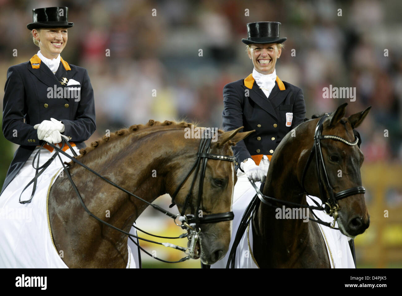 Dutch dressage riders Anky van Grunsven (R) and Marlies van Baalen smile while they sit on their horses at the World Equestrian Festival CHIO Aachen, Germany, 02 July 2009. The German team for the first time only won the silver medal in the Nations Cup of the world?s largest riding competition; the Dutch team finished on the first place. Photo: Rolf Vennenbernd Stock Photo