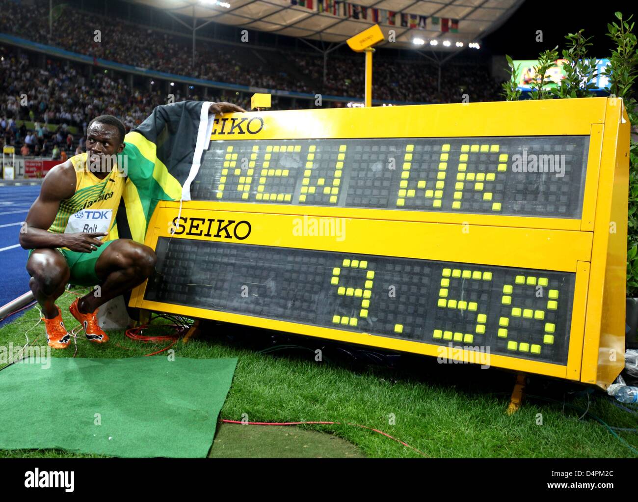 Jamaican Usain Bolt poses next to the display of his new world ...