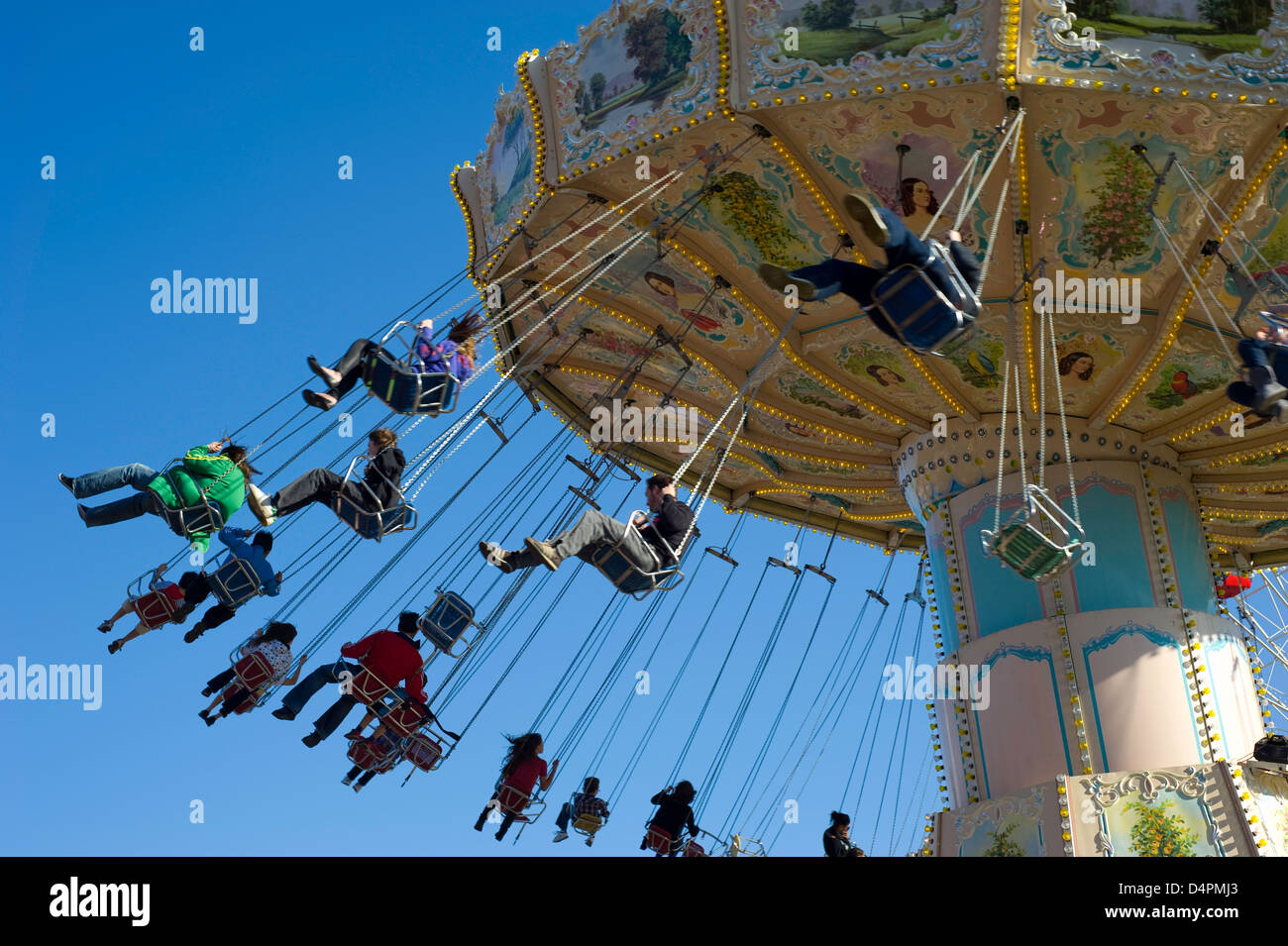 A mixed group of people at hight in on a fairground chair ride with ...