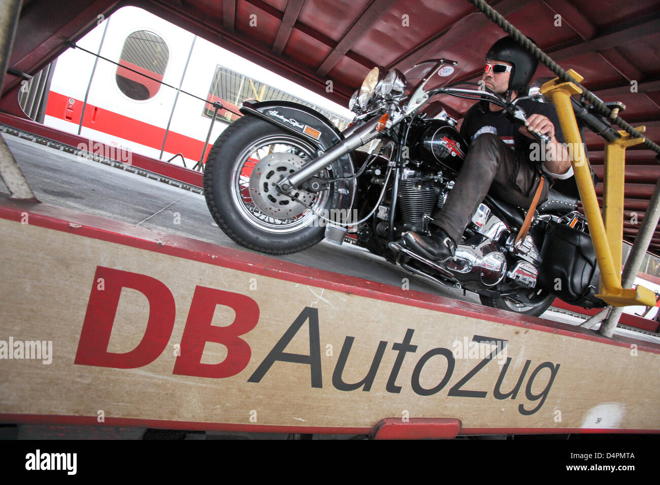 A biker enters a motorail train on his Harley-Davidson in Hamburg ...