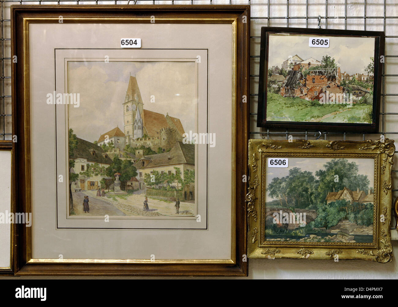 Three watercolours ?Zerschossene Muehle? (top R), ?Weissenkirchen in der Wachau? (L) and ?Haus mit Bruecke am Fluss? dated 1910 and 1911 by Adolf Hitler on display at an auction house in Nuremberg, Germany, 19 August 2009. The pieces will be auctioned at the beginning of September 2009. According to the auction house ?Weissenkirchen in der Wachau? had orginally been bought by a Jew Stock Photo