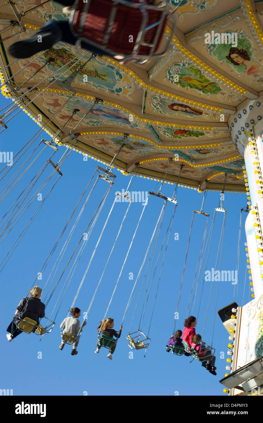 A mixed group of people at hight in on a fairground chair ride with ...