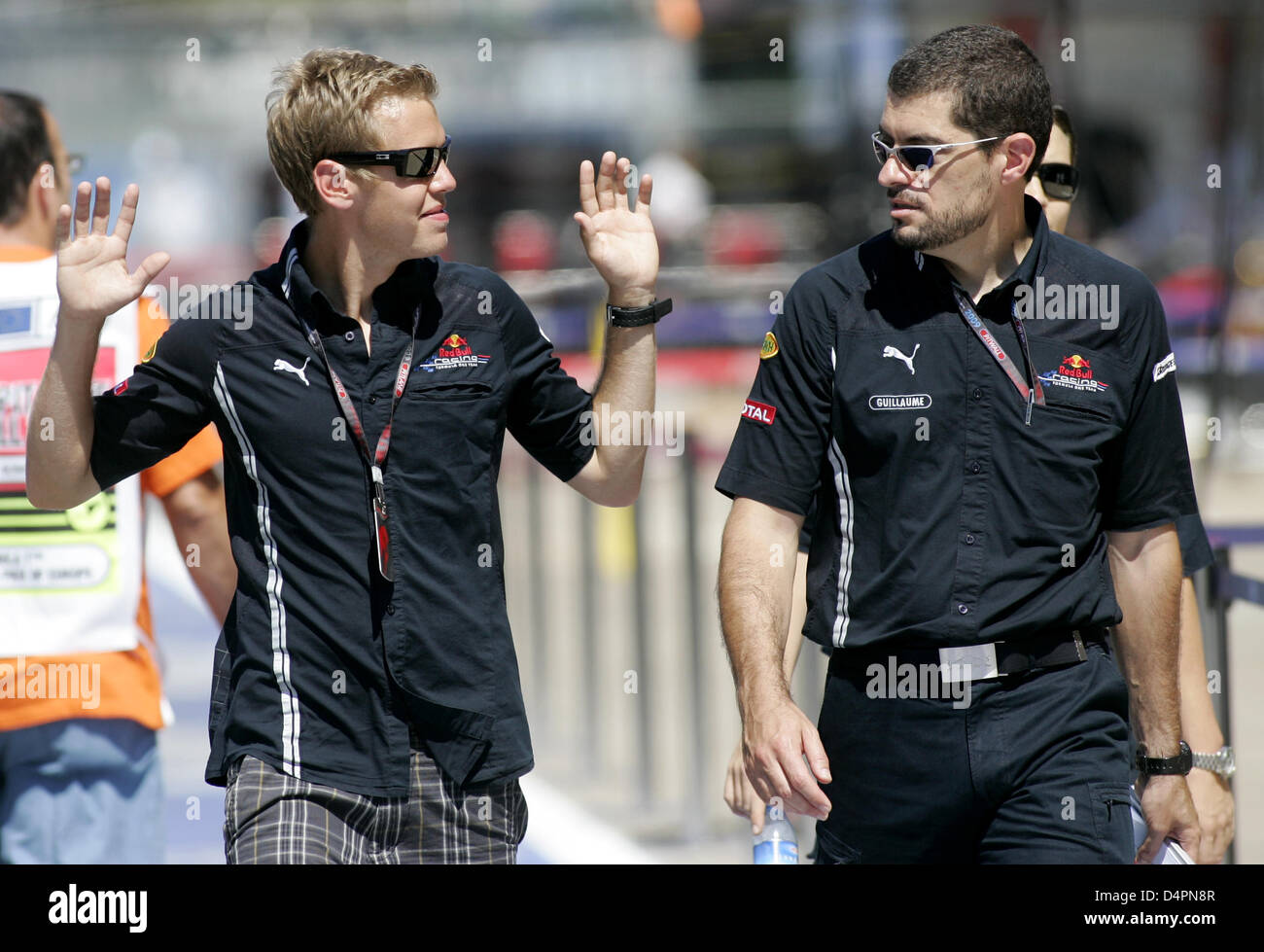 German Formula One driver Sebastian Vettel (L) and engineer Guillaume Rocquelin of Red Bull Racing inspect the Valencia Street Circuit in Valencia, Spain, 20 August 2009. The Grand Prix of Europe will take place on Sunday, 23 August 2009. Photo: Felix Heyder Stock Photo