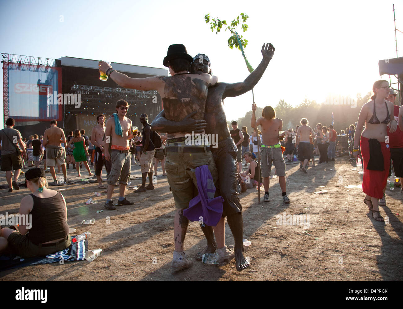 Two mud-covered festival goers dance in front of a stage during the Sziget Festival in Budapest, Germany, 15 August 2009. Photo: Friso Gentsch Stock Photo