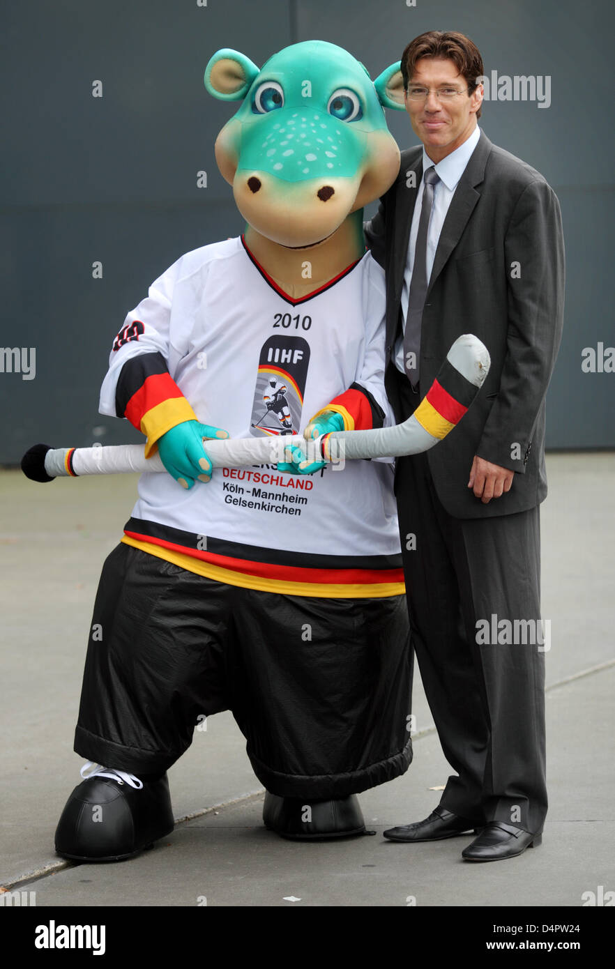 Uwe Krupp, head coach of Germany?s national ice hockey team, poses with the mascot for the Ice Hockey World Championships 2010 in Germany dubbed ?Urmel on the Ice? (?Urmel auf dem Eis?) during a photo call promoting the championships in Cologne, Germany, 02 September 2009. The Ice Hockey World Championships 2010 will take place in Germany from 07 May to 23 May 2010. Photo: Felix He Stock Photo