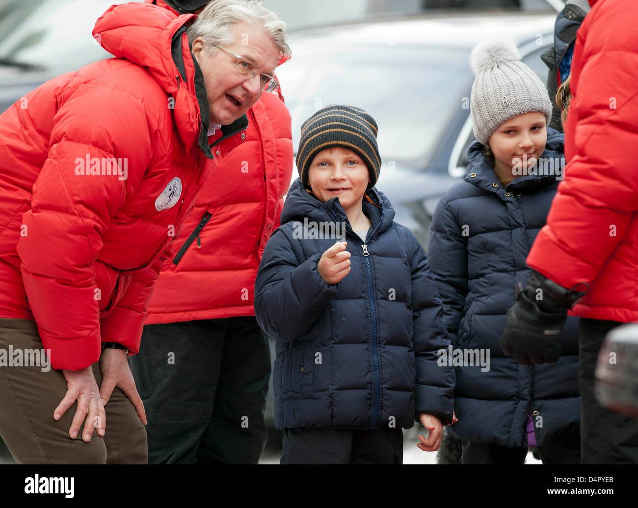 Prince Sverre Magnus of Norway (C) asks the mayor of Oslo, Fabian Stang (L), if photographers are all paparazzi... at right Princess Ingrid Alexandra. Pictured during their arrival at the ski jumping championship at Holmenkollen near Oslo. Oslo / Holmenkollen, 17-03-2013 Photo: RPE-Albert Nieboer / NETHERLANDS OUT Stock Photo