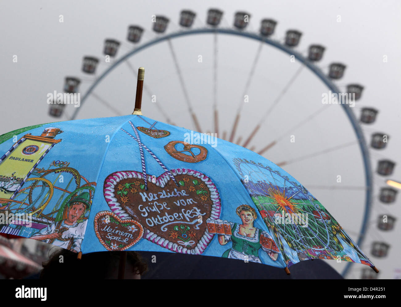 A colourful umbrella pistured in front of the big wheel of the 176th