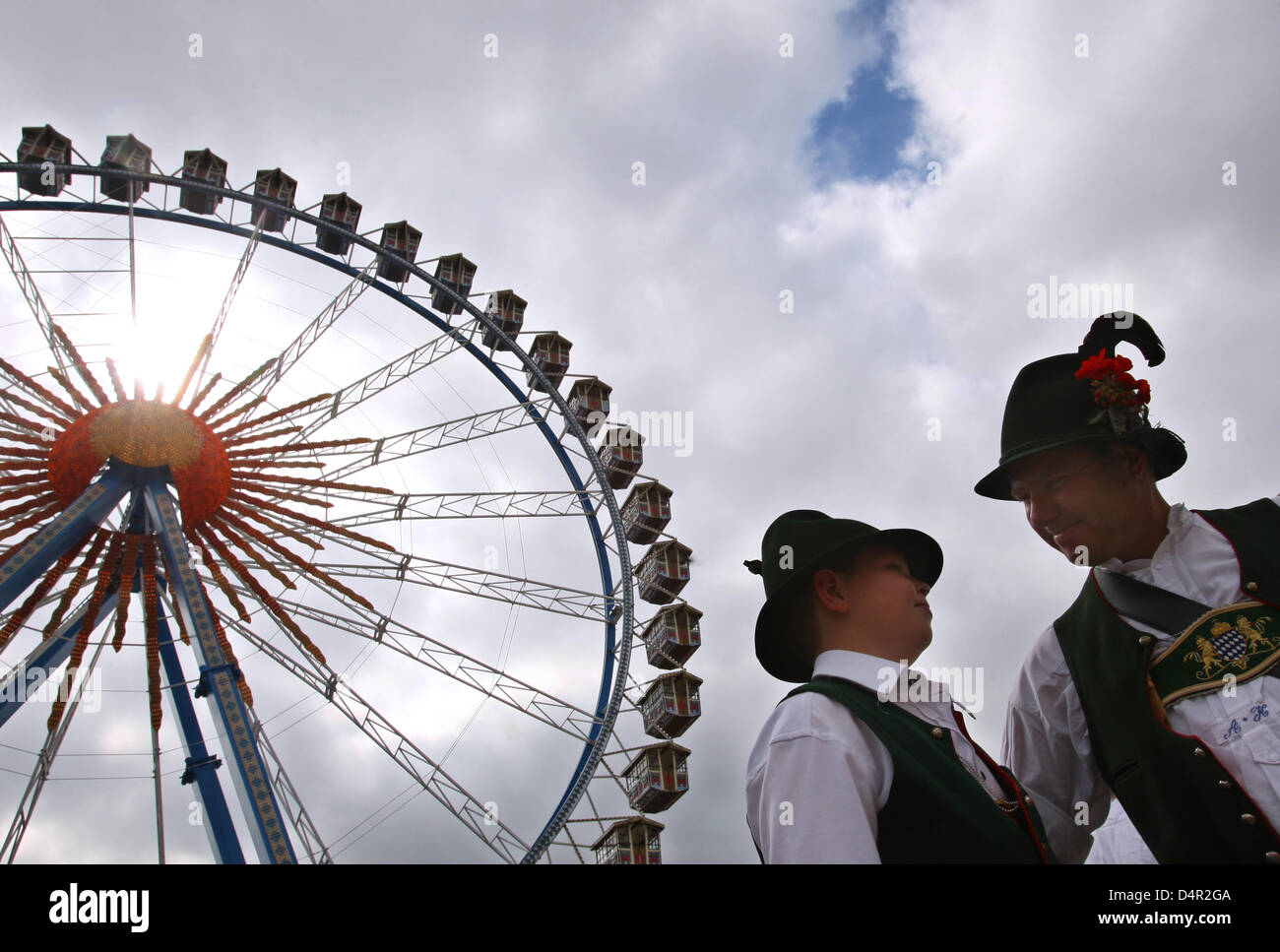 Visitors are dressed in traditional costume and stand in front of the