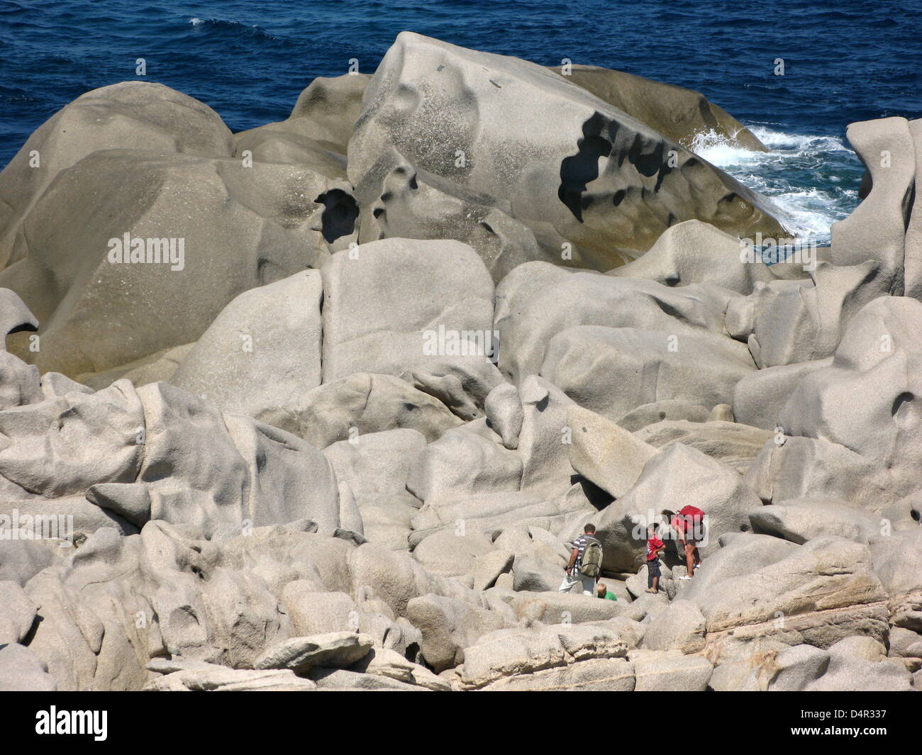 Tourists between bizarre granite rock formations at Sardinia?s ...