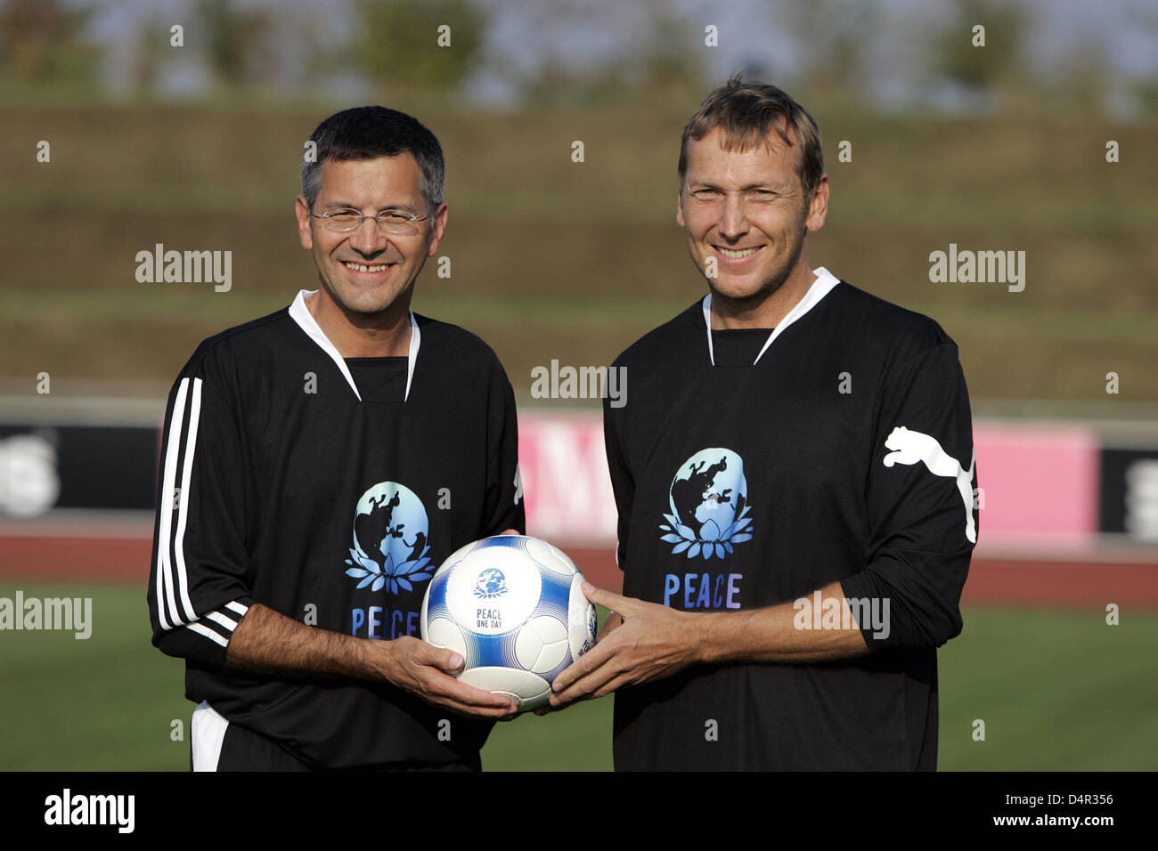 Adidas CEO, Herbert Hainer (L), and Puma CEO, Jochen Zeitz, on the pitch  ahead of a soccer friendly between two company sides in Herzogenaurach,  Germany, 21 September 2009. The friendly took place
